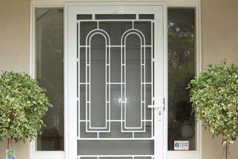 Decorative security screen door installed over a front door by Clearview Security