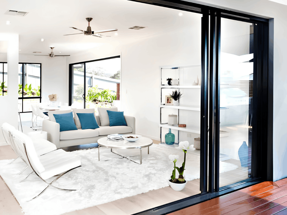 Black-framed sliding glass door opening into a bright apartment living room