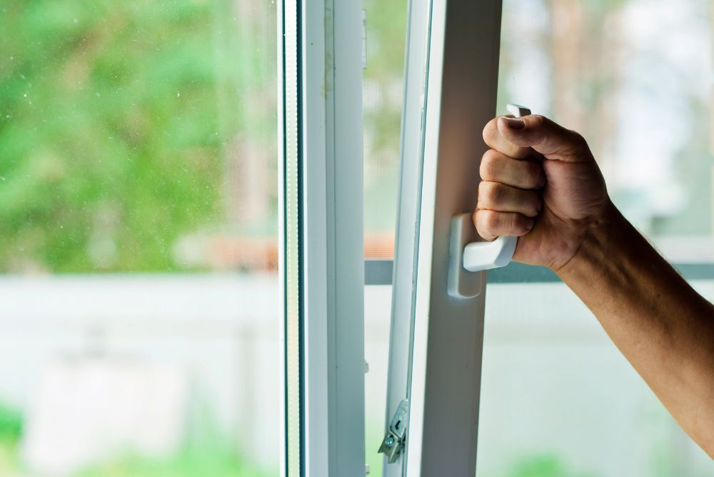 Hopper windows in an Australian home being opened internally.