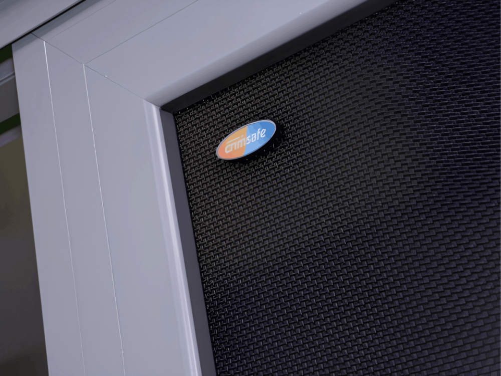 Close-up of black security mesh within a white door frame