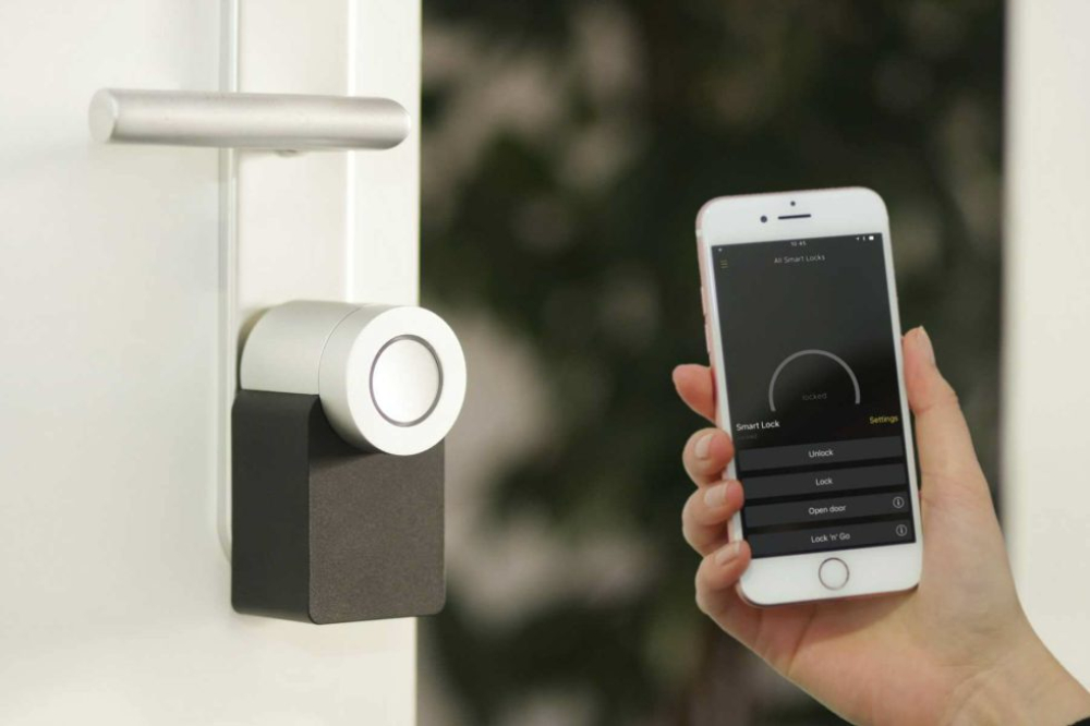 A homeowner using their phone to smart-lock a door