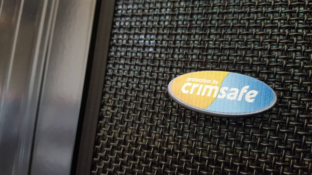 A close-up of Crimsafe mesh with the Crimsafe logo displayed