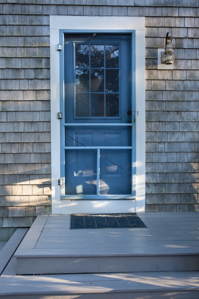 Hamptons style blue front door and screen
