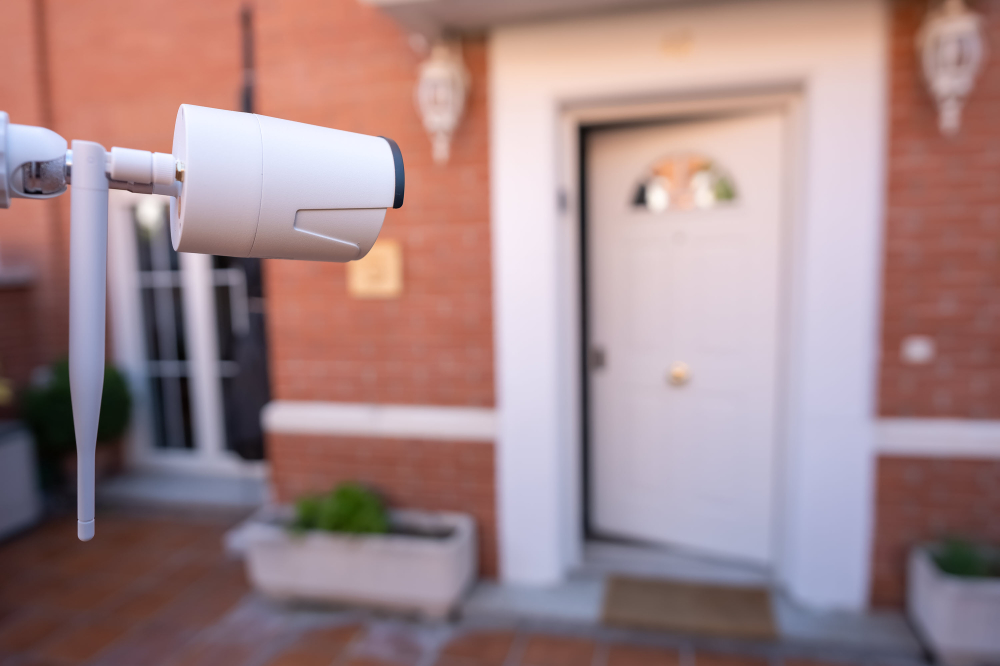 A home front door with a security camera in the foreground