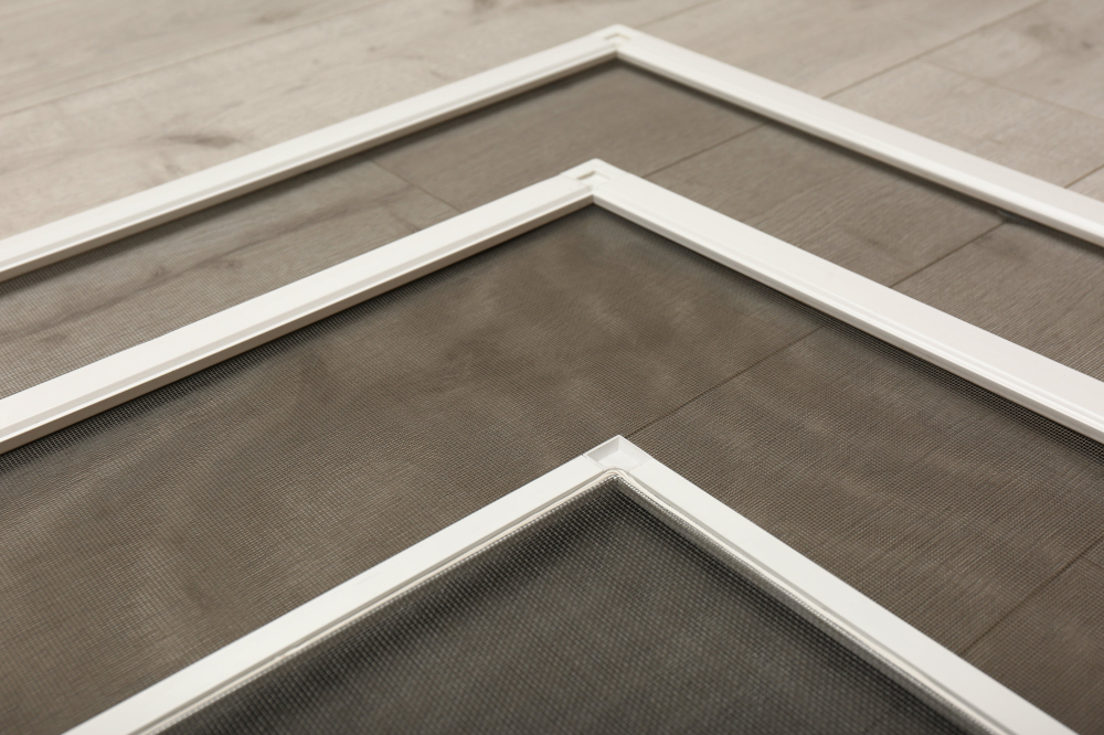 An image of window screens on a wooden floor