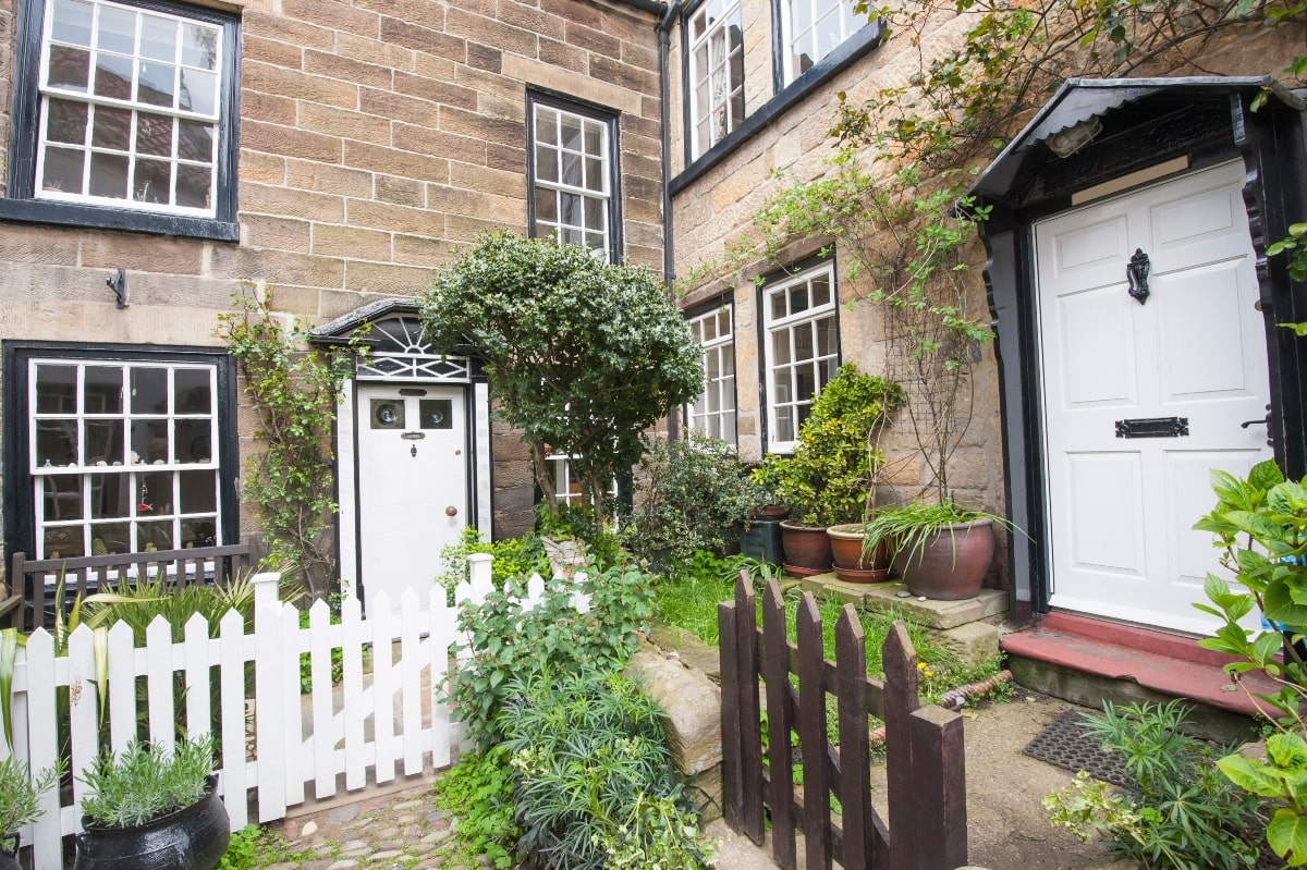 Exterior of English country homes with white front doors.