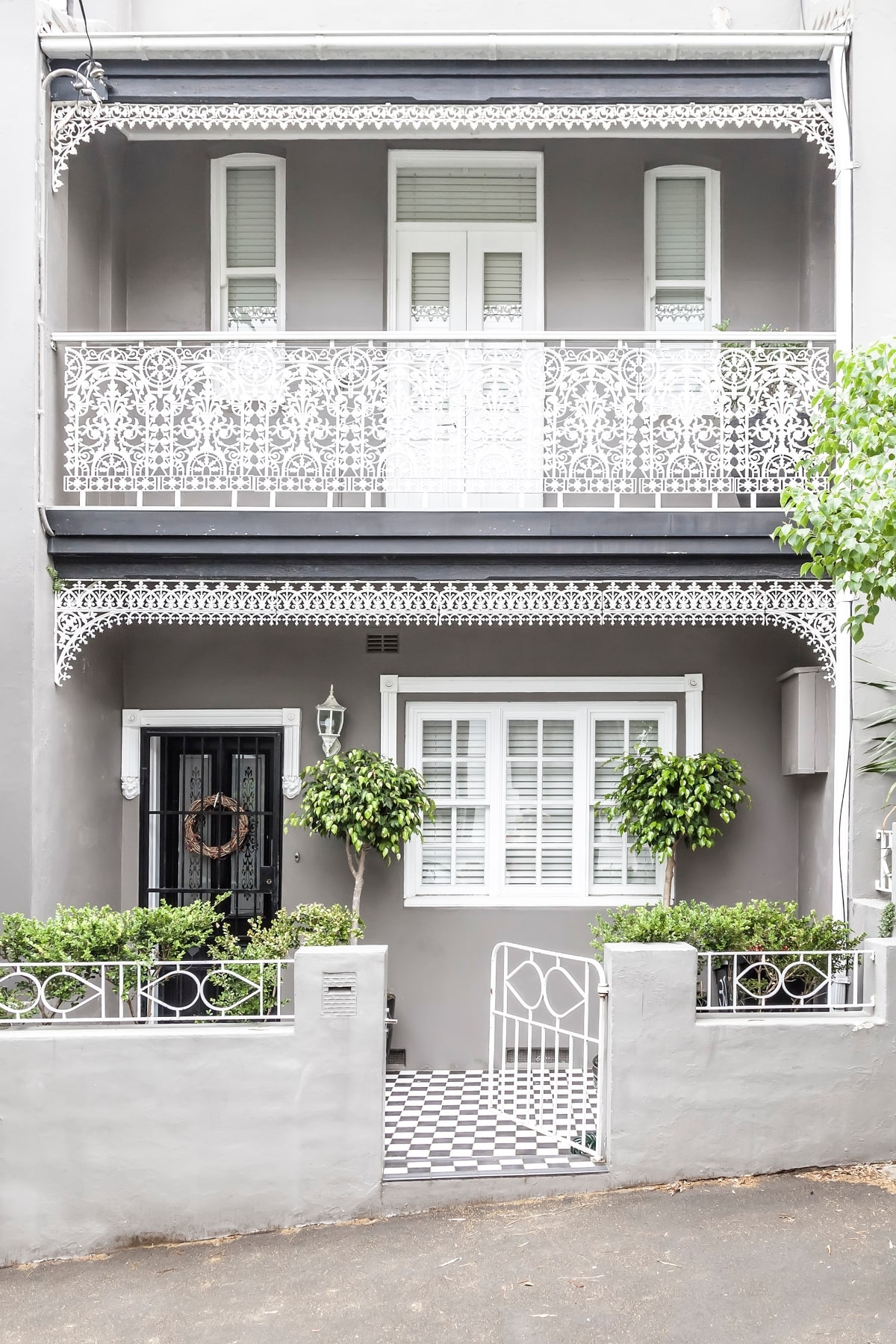Victoria terrace house, with black front door and ornate details.