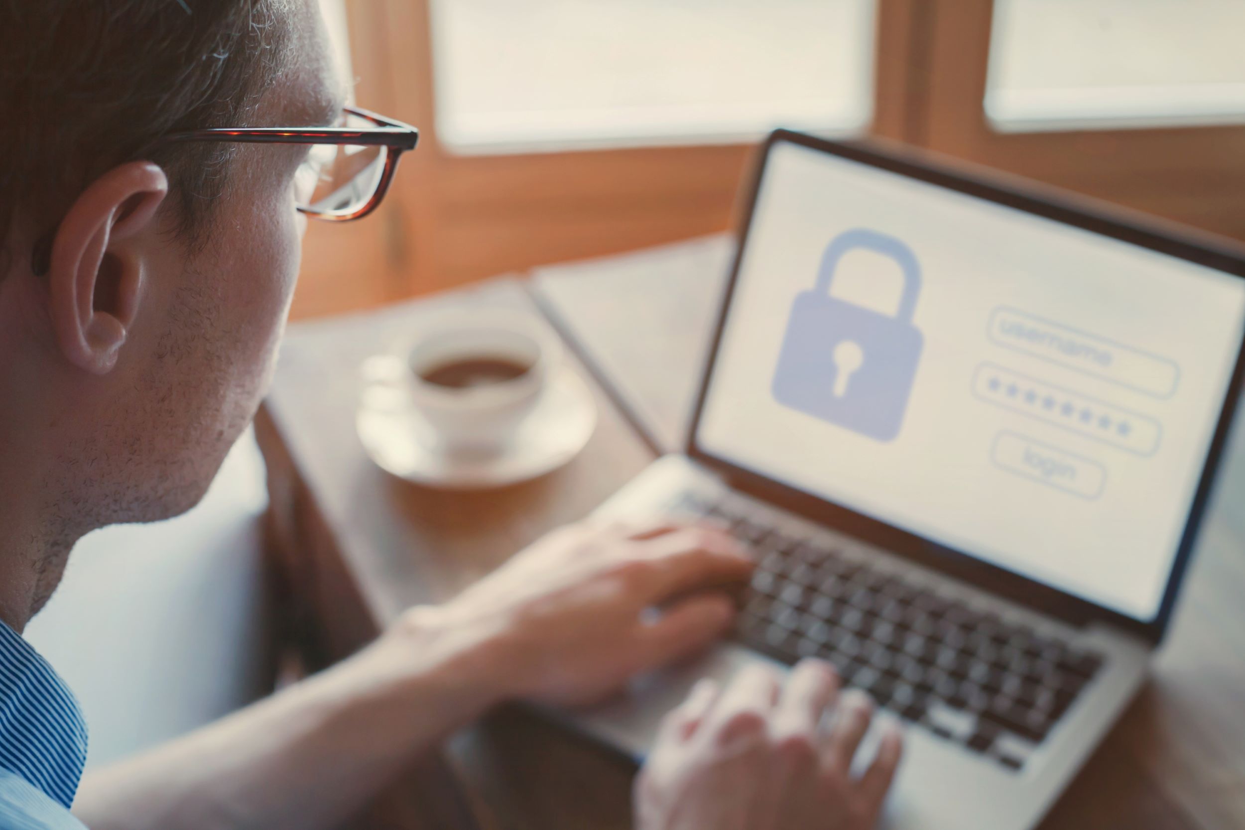 Person on Laptop with a lock symbol on the screen.